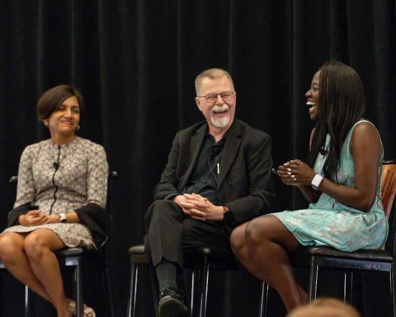 3 people sitting together and laughing