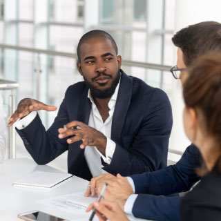 A male instructor teaching a group of employees.
