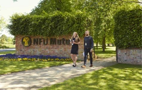 A man and a woman walking outside the NFU Mutual campus