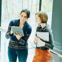 Two women talking in the hall.